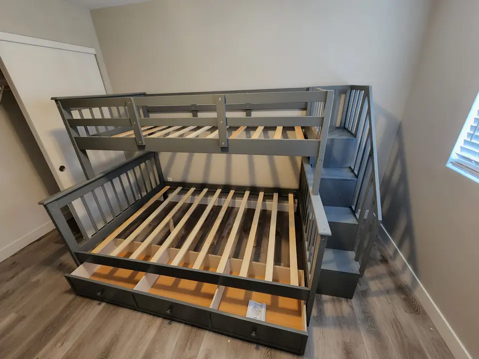 Assembled gray twin-over-full bunk bed with staircase drawers