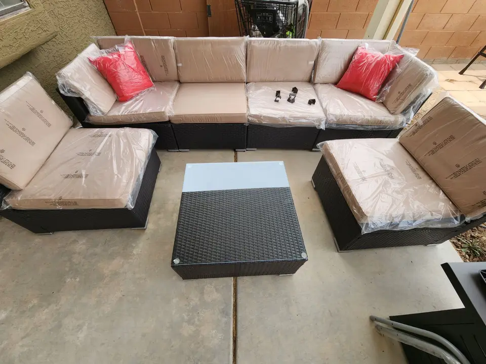 Assembled wicker patio sectional with a glass-top coffee table